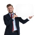 Positive businessman holding a blank speech bubble and laughing Royalty Free Stock Photo