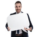 Positive businessman holding and presenting speech bubble Royalty Free Stock Photo