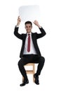 Positive businessman holding a speech bubble above his head Royalty Free Stock Photo