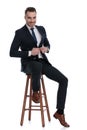 Positive businessman laughing and adjusting his jacket while sitting Royalty Free Stock Photo