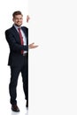 Positive businessman presenting an empty billboard and smiling Royalty Free Stock Photo