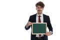 Positive businessman presenting green blackboard and smiling Royalty Free Stock Photo