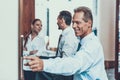 Positive businessman pushing the elevator button and smiling Royalty Free Stock Photo