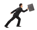 Positive businessman running and holding briefcase Royalty Free Stock Photo