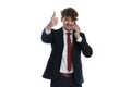 Positive businessman talking on phone and giving thumbs up Royalty Free Stock Photo