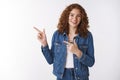 Positive carefree friendly smiling redhead girl without makeup pointing left show awesome promotion grinning happily