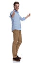 Positive casual man gesturing ok and presenting