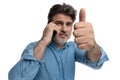 Positive casual man giving a thumbs up, talking on phone Royalty Free Stock Photo