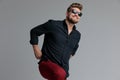 Positive casual man laughing and pulling his red pants Royalty Free Stock Photo