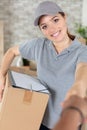 positive charming deliverywoman holding parcel Royalty Free Stock Photo