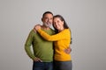 Positive cheerful caucasian retired couple hugs, enjoy date together, romance and positive lifestyle