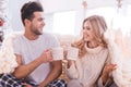 Positive cheerful couple having tea