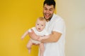 Positive cheerful dad holds his son in his arms. Happy parent and baby Royalty Free Stock Photo