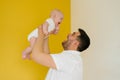 Positive cheerful dad holds his son in his arms. Happy parent and baby Royalty Free Stock Photo