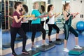 Positive females working out on aerobic step platform Royalty Free Stock Photo