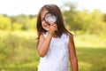 Positive cheerful little girl looking through a magnifying glass