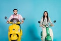 Positive cheerful two lovely bikers man woman drive their motor bike wear striped shirt pink isolated over blue color Royalty Free Stock Photo