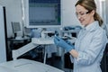 Positive cheerful woman working with scientific equipment