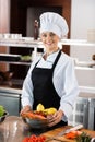 Positive chef in cap looking at