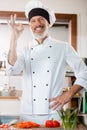 Positive chef showing ok gesture near