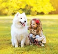 Positive child and dog having fun outdoors Royalty Free Stock Photo