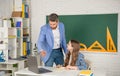positive child with teacher in classroom use laptop Royalty Free Stock Photo