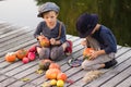 Positive children paint small Halloween pumpkins