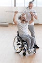 Positive coach teaching and helping the invalid in the gym Royalty Free Stock Photo