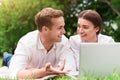 Positive colleagues resting on the grass, Royalty Free Stock Photo