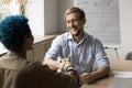 Positive confident businessman giving greeting handshake to female client Royalty Free Stock Photo