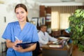 Positive confident young female doctor in a resident's office, writes important notes Royalty Free Stock Photo