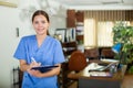 Positive confident young female doctor in a resident's office, writes important notes Royalty Free Stock Photo