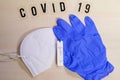 A positive corona rapid test lies next to a medical face mask and a blue medical glove