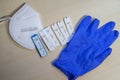 Six positive corona rapid tests lie next to a medical face mask and a blue medical glove Royalty Free Stock Photo