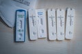 Six positive corona rapid tests lie next to a medical face mask