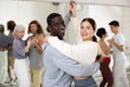 Positive couple of dancers learns a slow foxtrot