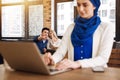 Positive couple pointing at muslim woman