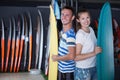 Positive couple is satisfied of choose surfboard Royalty Free Stock Photo