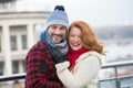 Positive couple wearing warm clothes and smiling happily