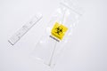 Positive covid self-test and swab in biohazard bag