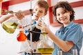 Positive curious boys visiting a scientific club