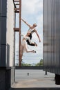 Positive dancers posing on ladder on