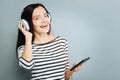 Positive delighted brunette listening favorite song