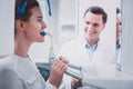 Positive delighted dentist looking at his young patient Royalty Free Stock Photo