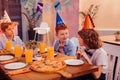 Positive delighted kids sitting together in cafe