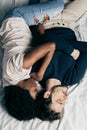 Young couple sleeping together on bed in bedroom, embracing each other sweetly Royalty Free Stock Photo