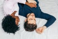 Young couple sleeping together on bed in bedroom, embracing each other sweetly Royalty Free Stock Photo