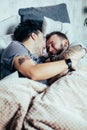 Positive delighted non-traditional couple sleeping together Royalty Free Stock Photo