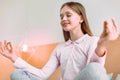 Positive delighted schoolgirl sitting with closed eyes