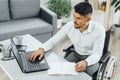 Positive disabled young man in wheelchair working in office Royalty Free Stock Photo